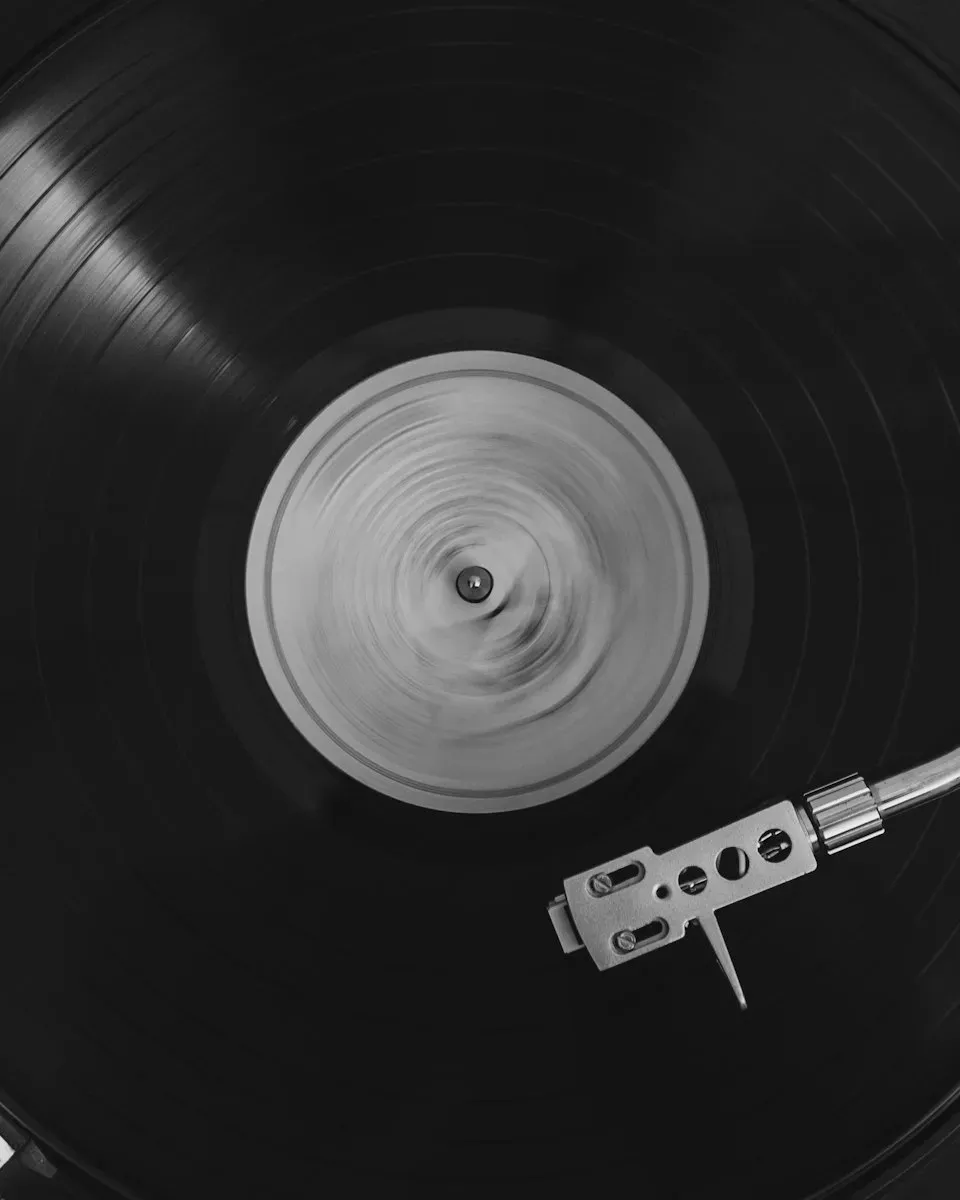 A record spinning on a turntable, in black and white.