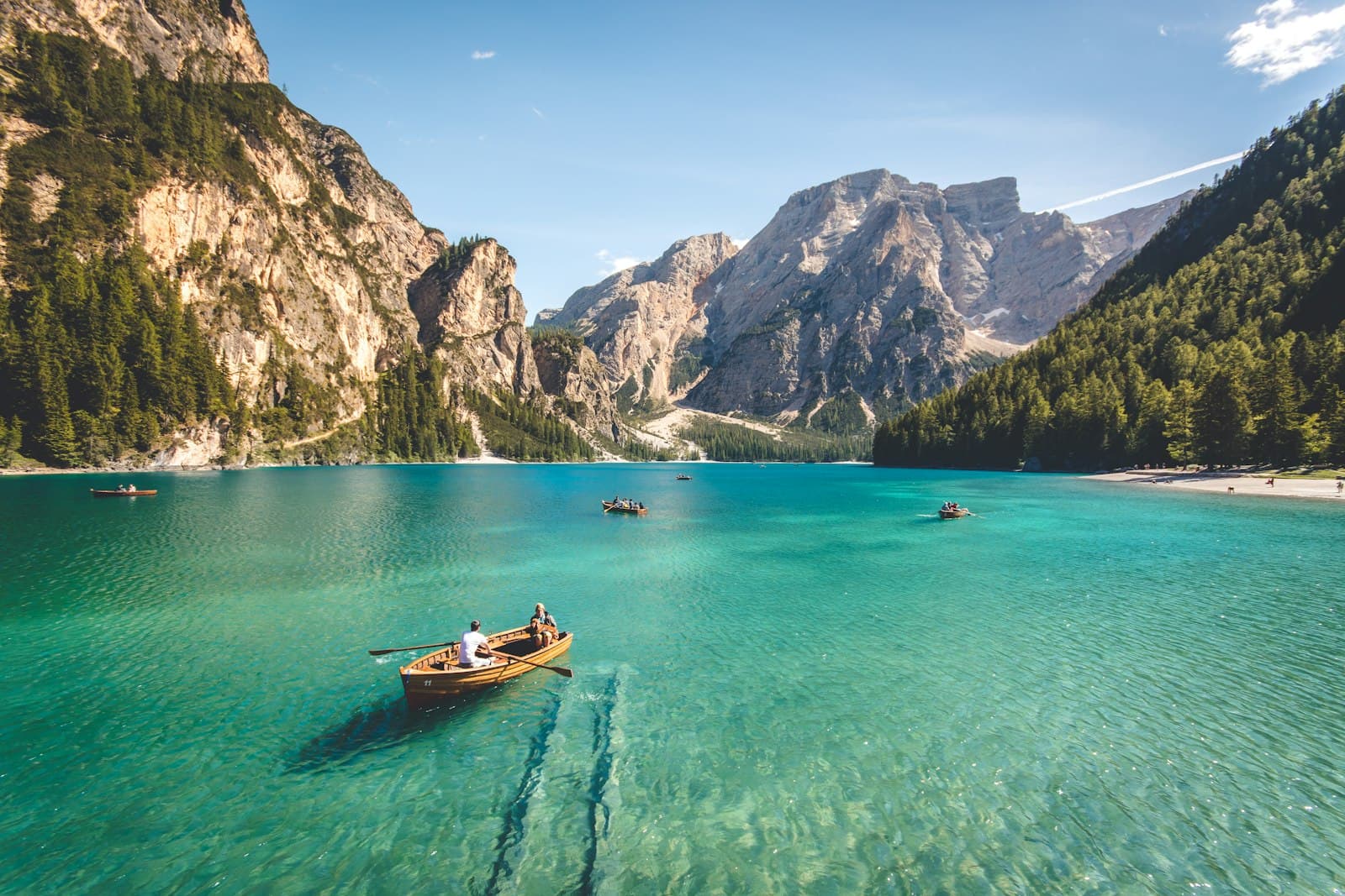 Placeholder: a rowing boat on a turquoise mountain lake.