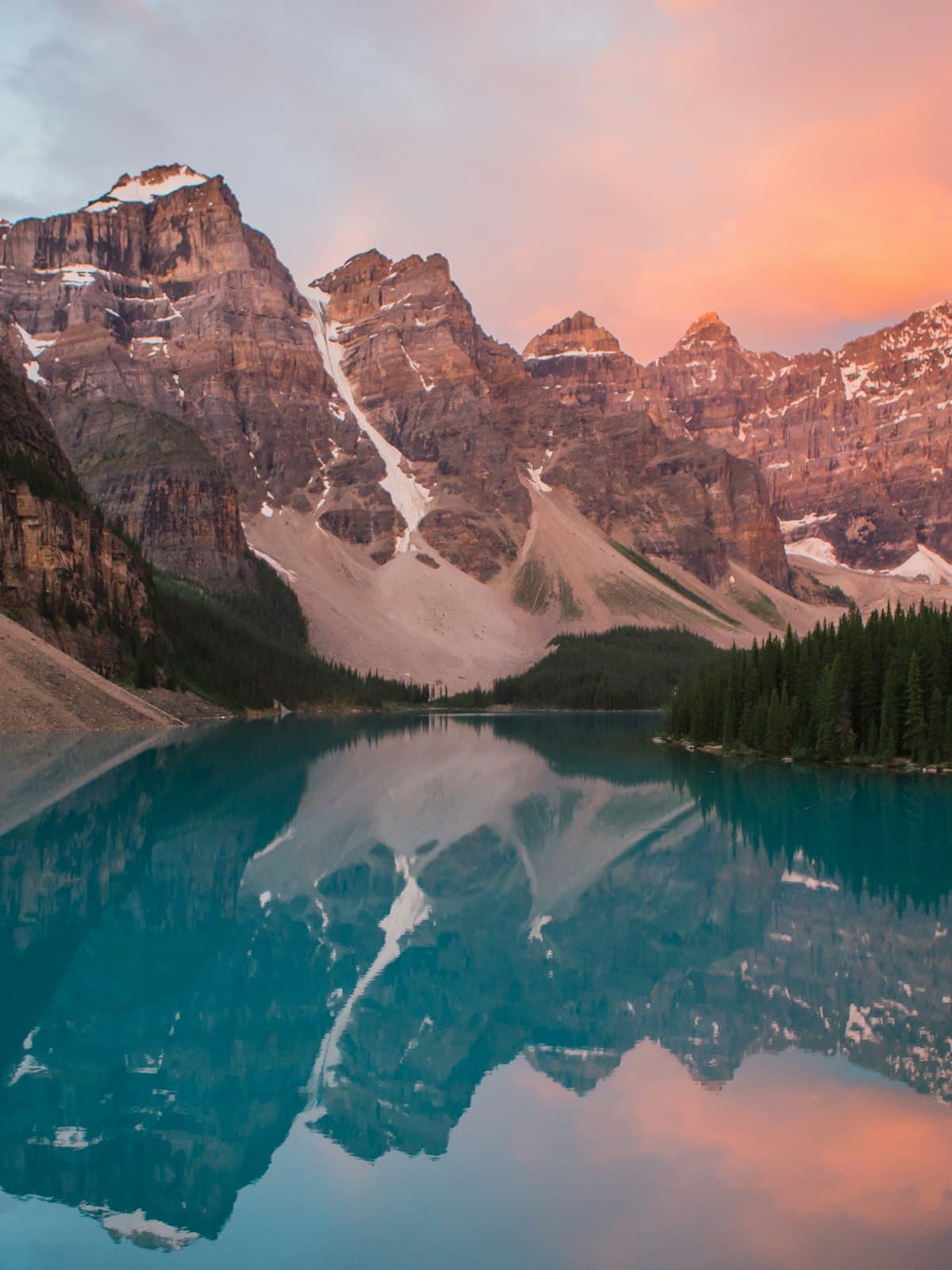 Placeholder: pink mountains reflected in a glacial lake.